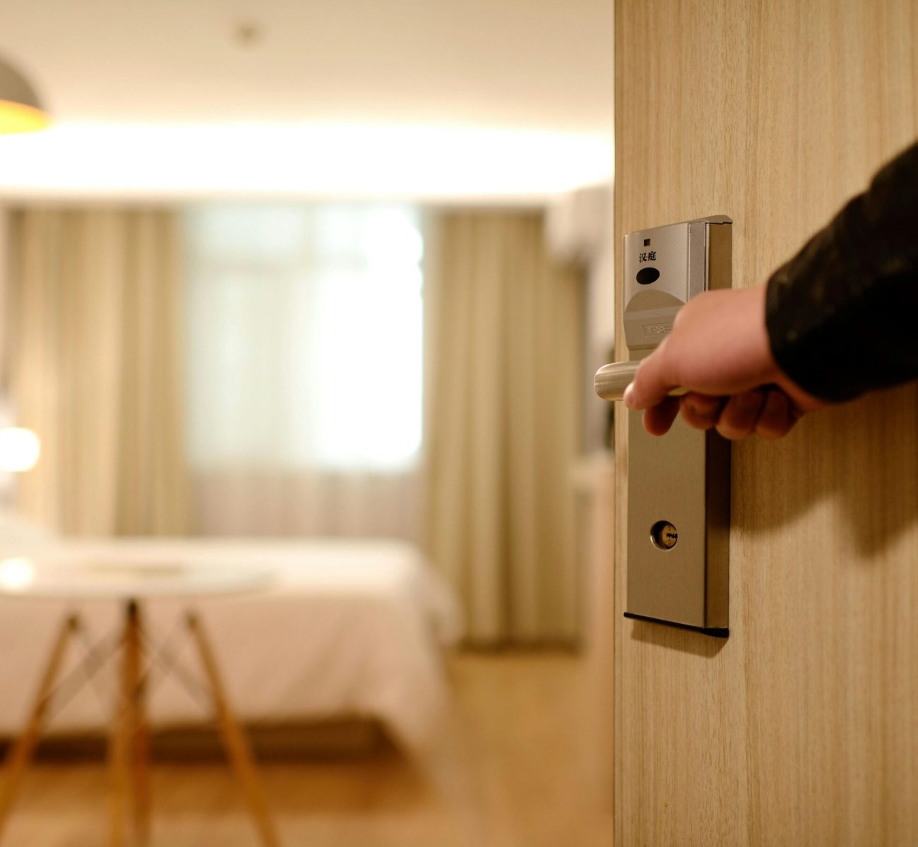 A soft-lit hotel room entrance, welcoming guests with luxury appeal and comfort.